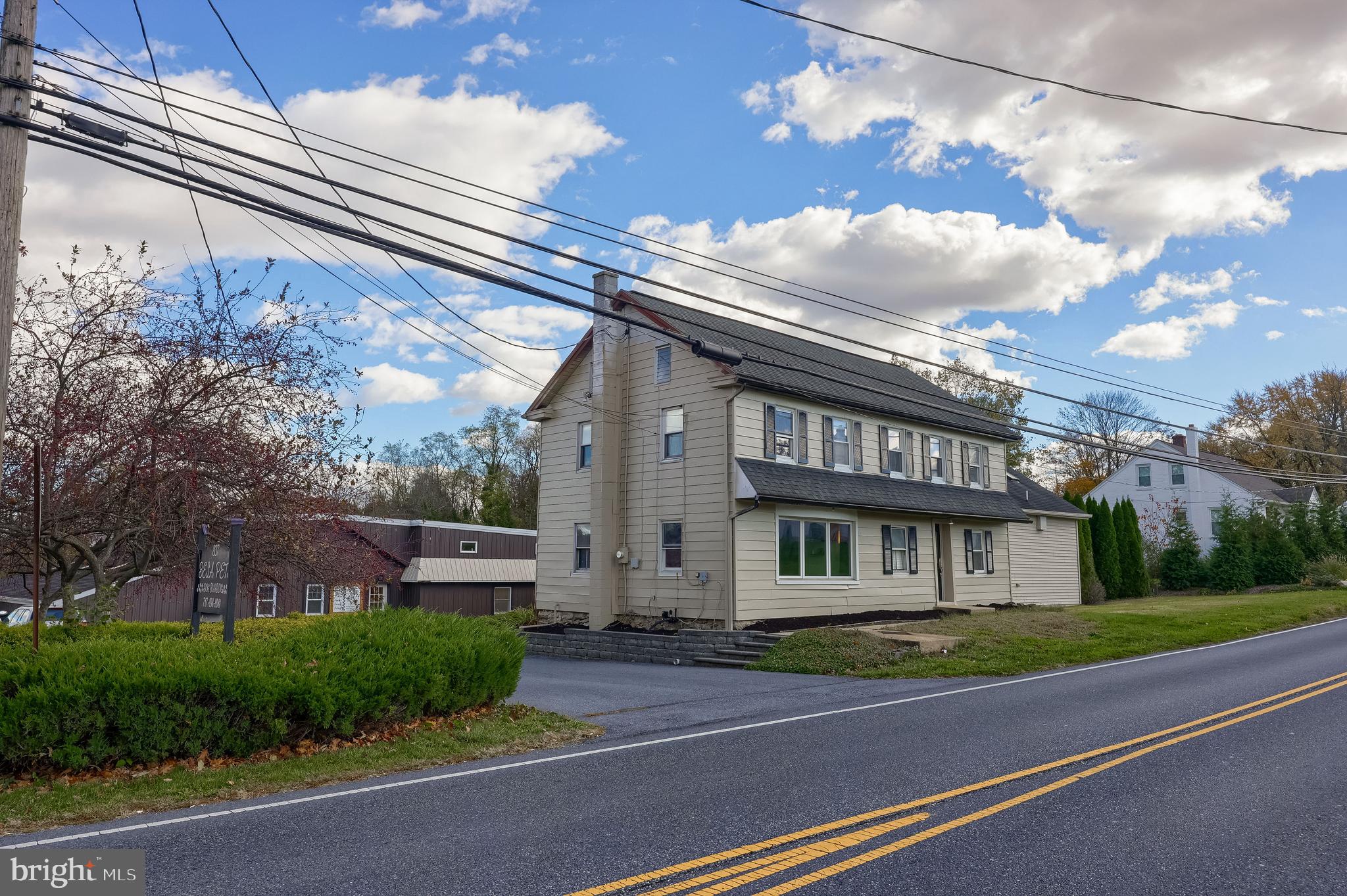 837 Centerville Road Lancaster, PA 17601 - Photo 90 of 91 a view of a white building among the street with palm trees