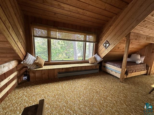 2763 Van Vac Road Ely, MN 55731 - Photo 21 of 37 Room featuring sloped wood-paneled ceilings and walls, a built-in window seat, large windows, and wall-to-wall carpeting