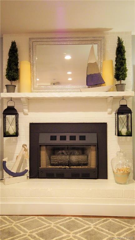 3472 Lake Shore Road South Denver, NC 28037 - Photo 22 of 31 a living room with a fireplace and cabinets