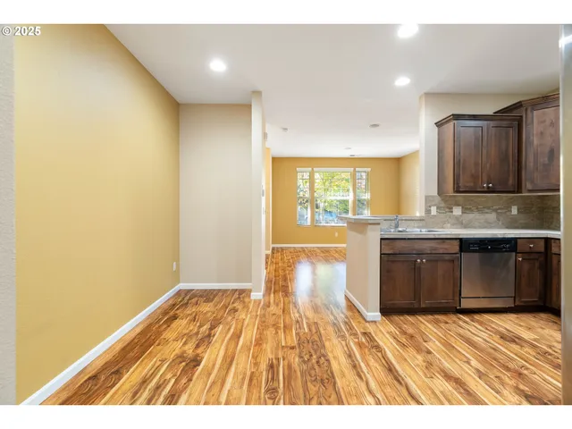 a kitchen with granite countertop a stove a sink and a microwave