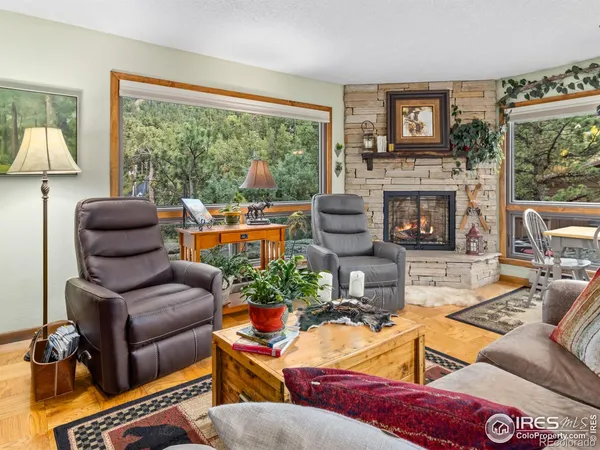 a living room with furniture fireplace and a large window