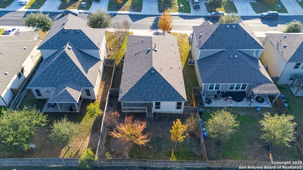 an aerial view of a house with a yard