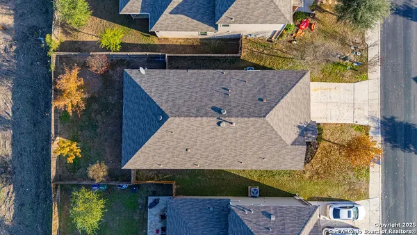 aerial view of a house with a yard