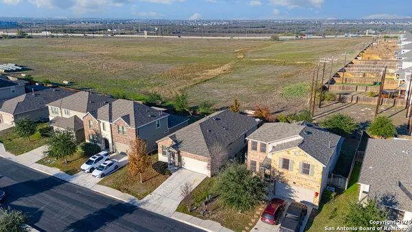 an aerial view of residential building with outdoor space and ocean view