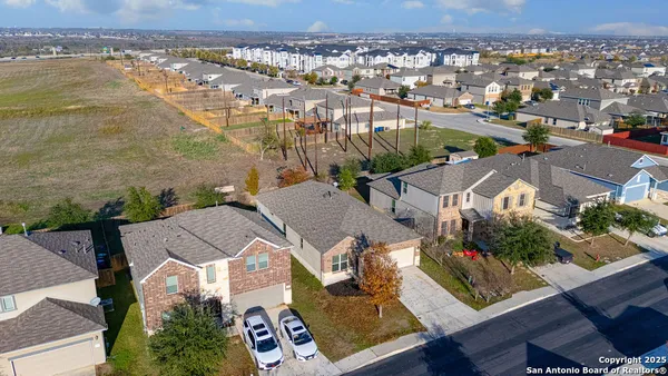 an aerial view of residential houses with outdoor space