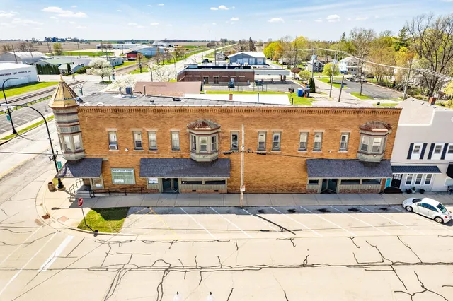 a view of a room with wooden floor and furniture