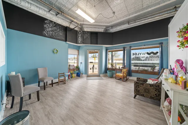 a living room filled with furniture and a chandelier
