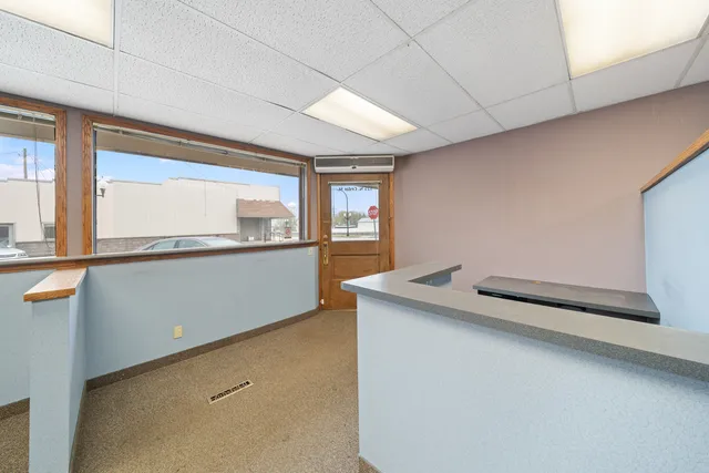 a kitchen with a sink cabinets and a wooden floor