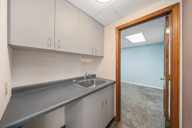 en empty room with windows and ceiling fan