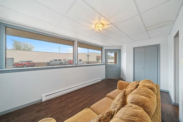 a living room with hard wood floors and a ceiling fan