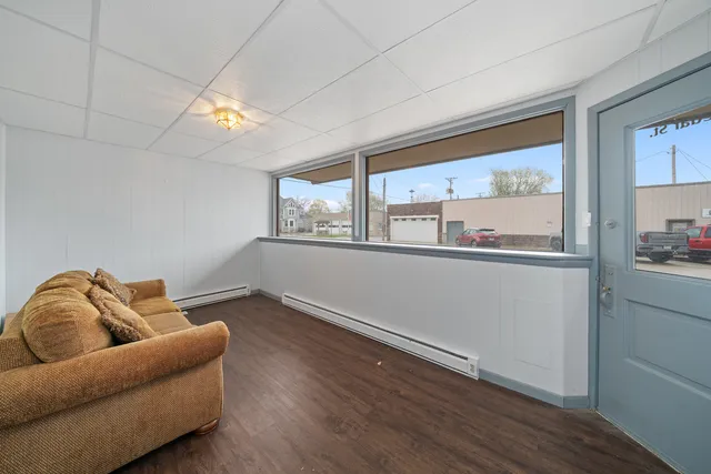 a view of an empty room with wooden floor