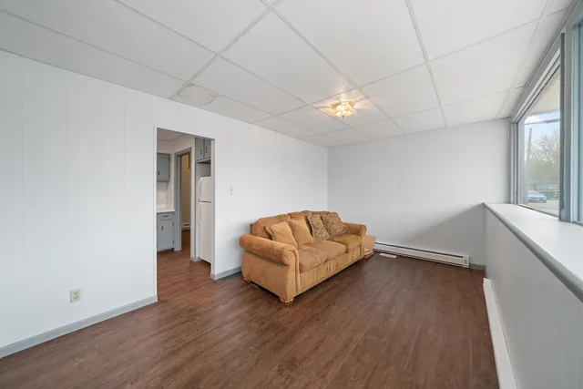 a kitchen with a sink a refrigerator and cabinets