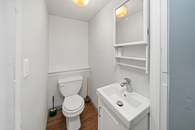 a white toilet sitting next to a bathroom sink