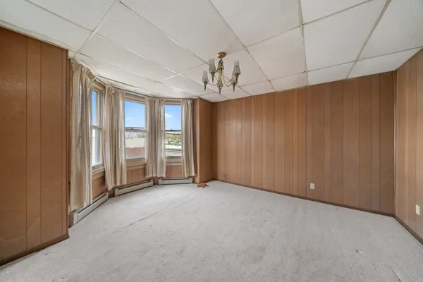 a kitchen with refrigerator and cabinets