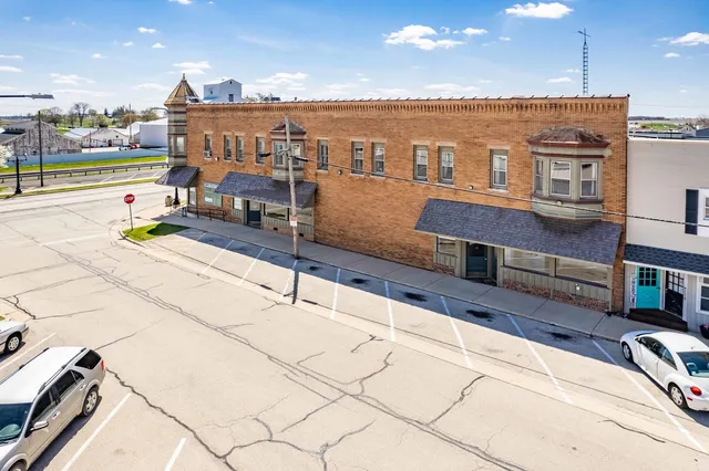 a front view of a building with a yard