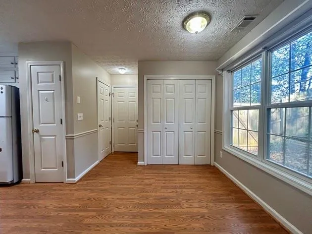 an empty room with windows and closet
