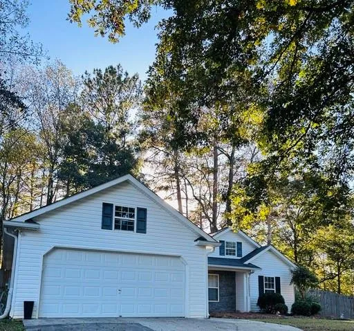 a front view of house with yard and trees