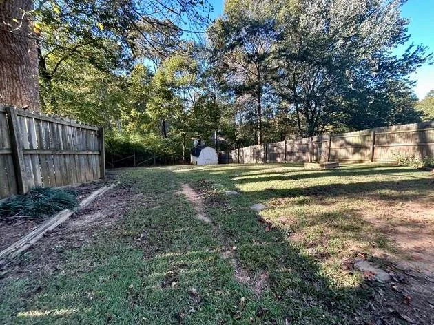 a view of a backyard with large trees