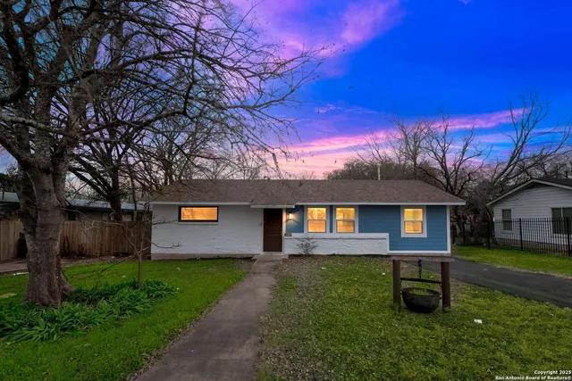 a front view of a house with a garden and yard