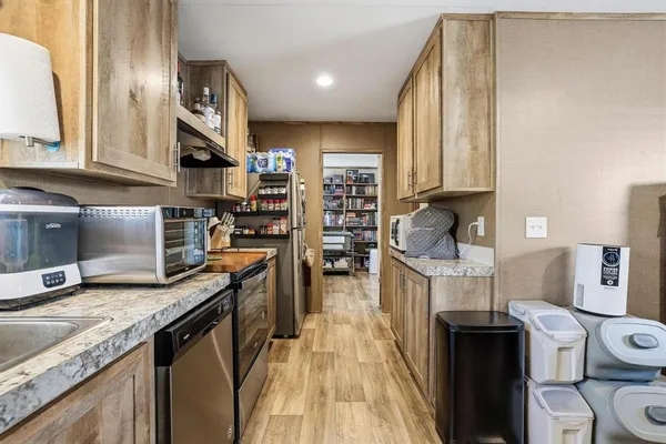 a kitchen with stainless steel appliances granite countertop a sink stove and refrigerator