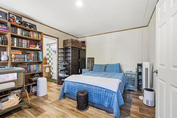 a bed room with a bed and a book shelf