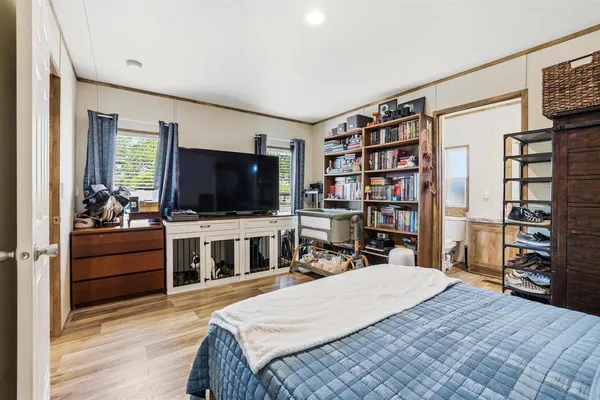 a bedroom with a bed and a flat screen tv