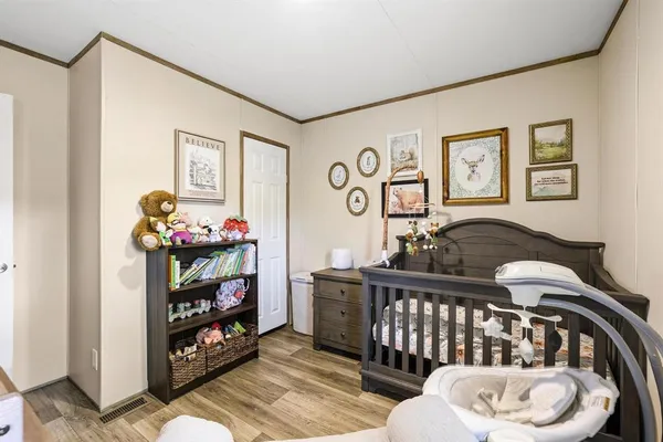 a bedroom with furniture and a chair
