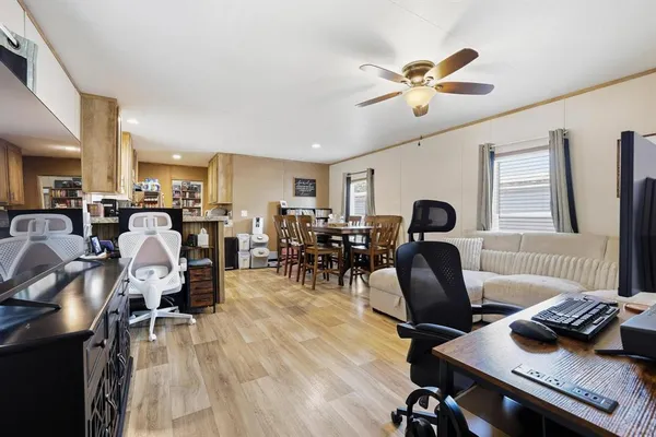 a living room with furniture and wooden floor