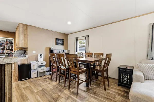 a view of a dining room with furniture and wooden floor