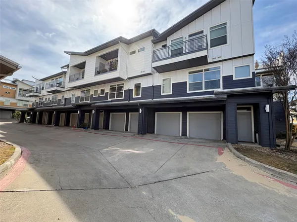 a large bed sitting in a bedroom next to a large window