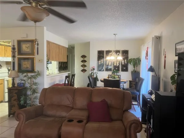 a living room with furniture and a chandelier