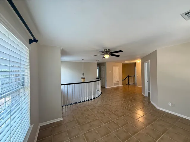 a view of a livingroom with a ceiling fan and window