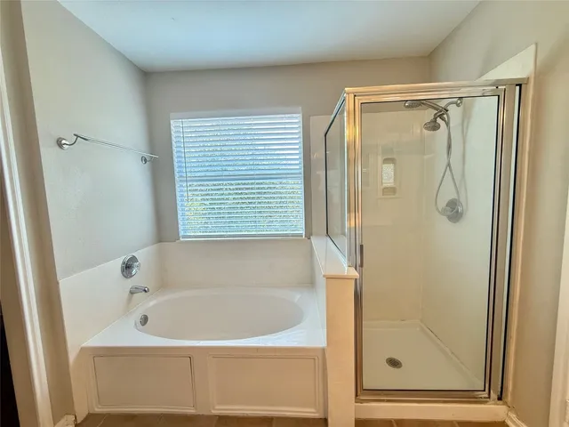 a bathroom with a bathtub and a shower