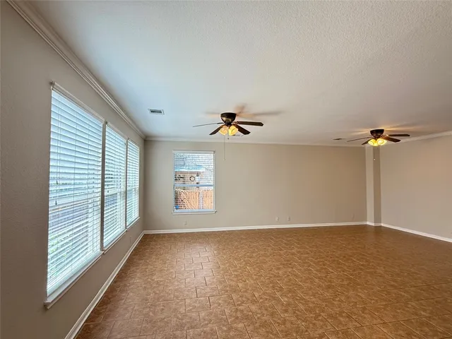 a view of room with a ceiling fan and window