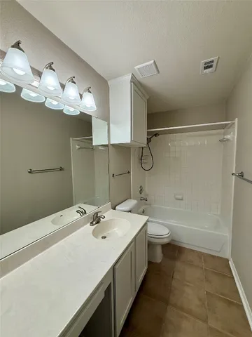 a bathroom with a double vanity sink a toilet and a shower