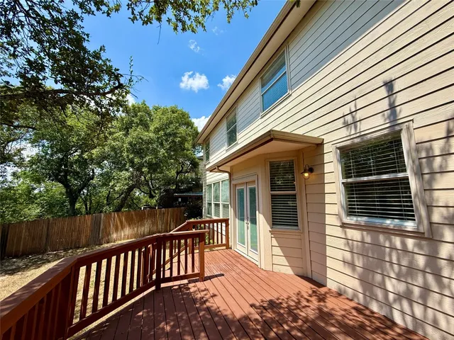 a view of a house with a small deck