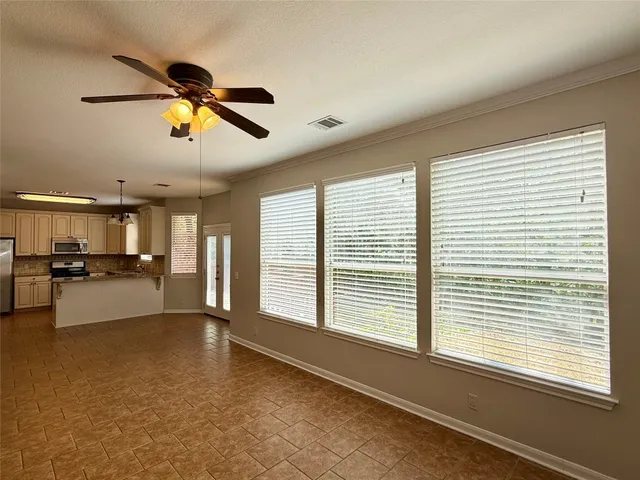 a view of a living room and kitchen with furniture and windows
