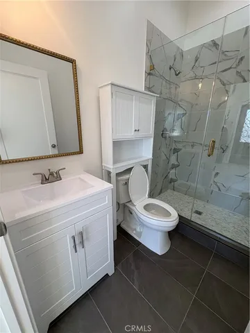 a bathroom with a toilet sink and a mirror