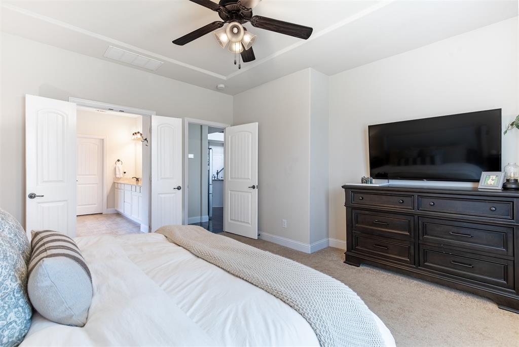 717 Rio Concho Trail McKinney, TX 75071 - Photo 20 of 37 Primary suite with double-door entry to en-suite bath.