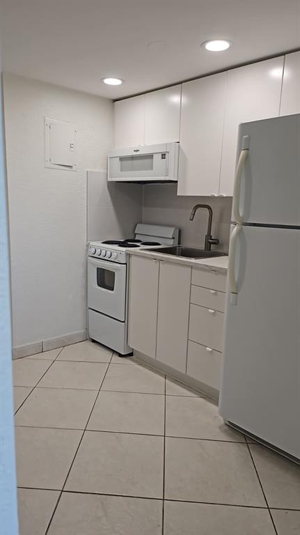 3000 East Sunrise Boulevard Fort Lauderdale, FL 33304 - Photo 6 of 14 a kitchen with stainless steel appliances a refrigerator sink and cabinets