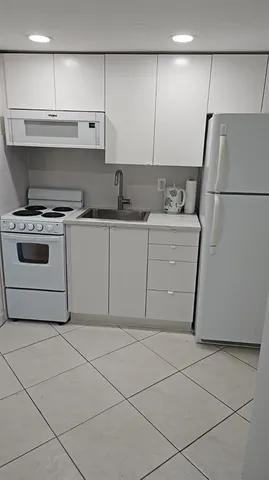 a view of a livingroom with an empty space and wooden floor