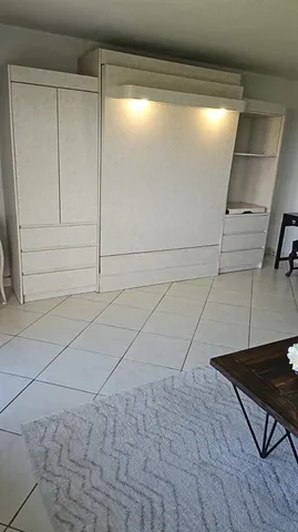 a bedroom with a bed a mirror and dresser