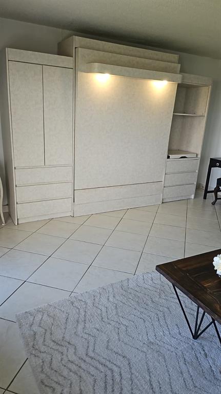 3000 East Sunrise Boulevard Fort Lauderdale, FL 33304 - Photo 10 of 14 a view of a livingroom with an empty space and wooden floor