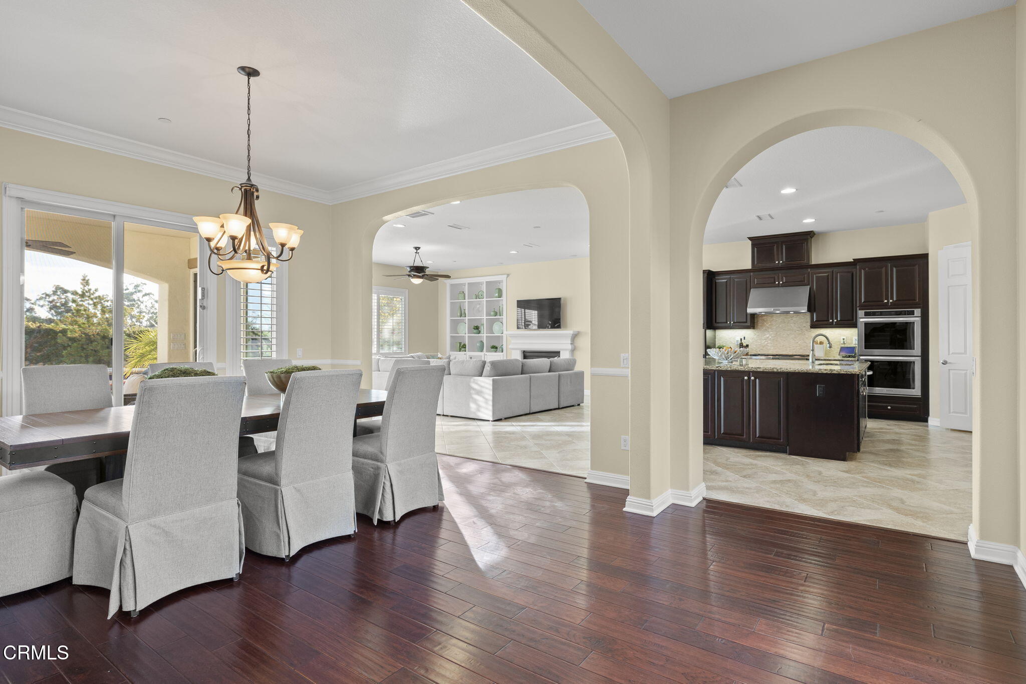 7391 Elk Run Way Moorpark, CA 93021 - Photo 16 of 56 a view of a dining room and livingroom with furniture wooden floor kitchen view and a chandelier