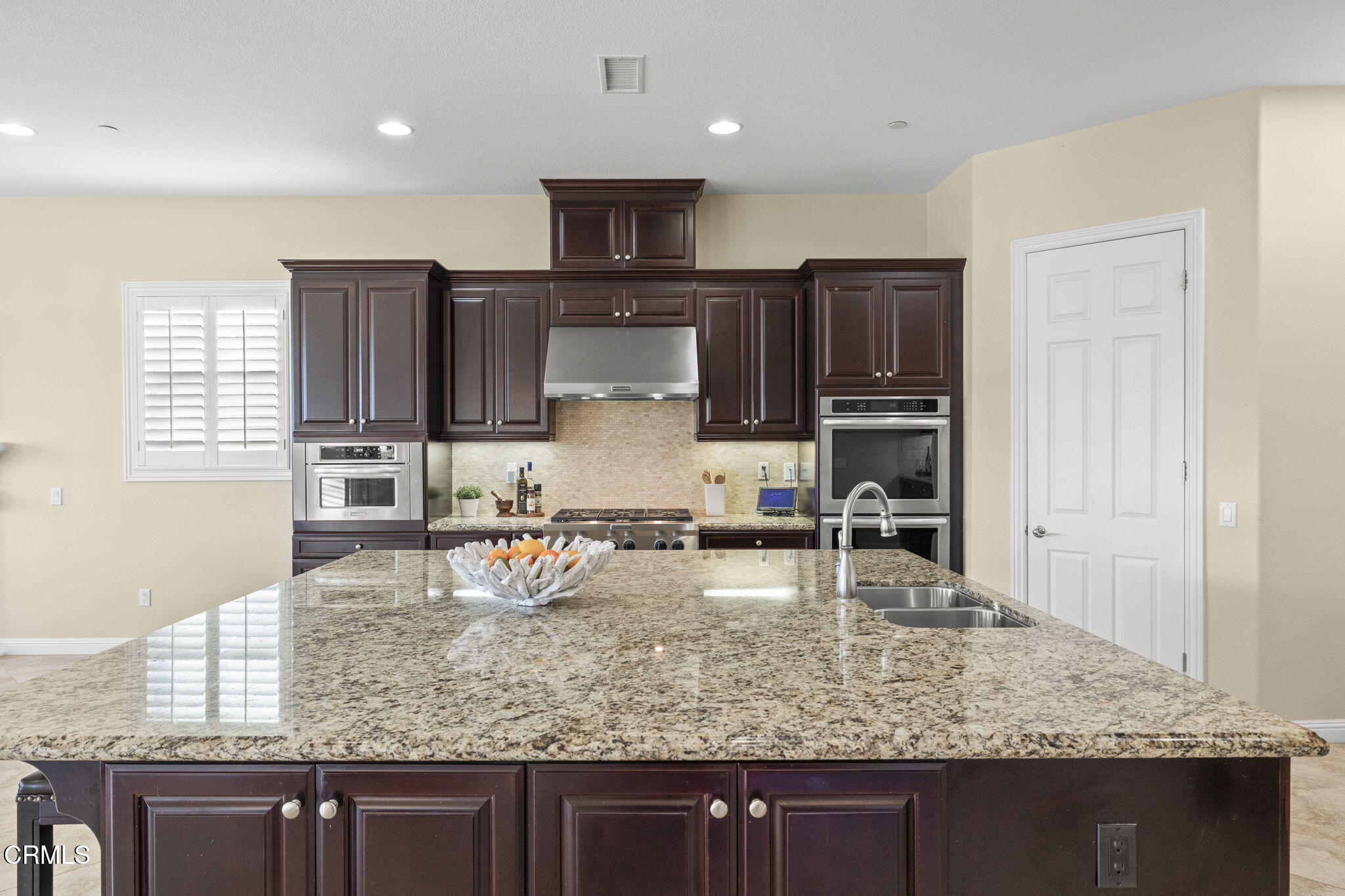 7391 Elk Run Way Moorpark, CA 93021 - Photo 21 of 56 a kitchen with kitchen island granite countertop a sink counter top space appliances and cabinets
