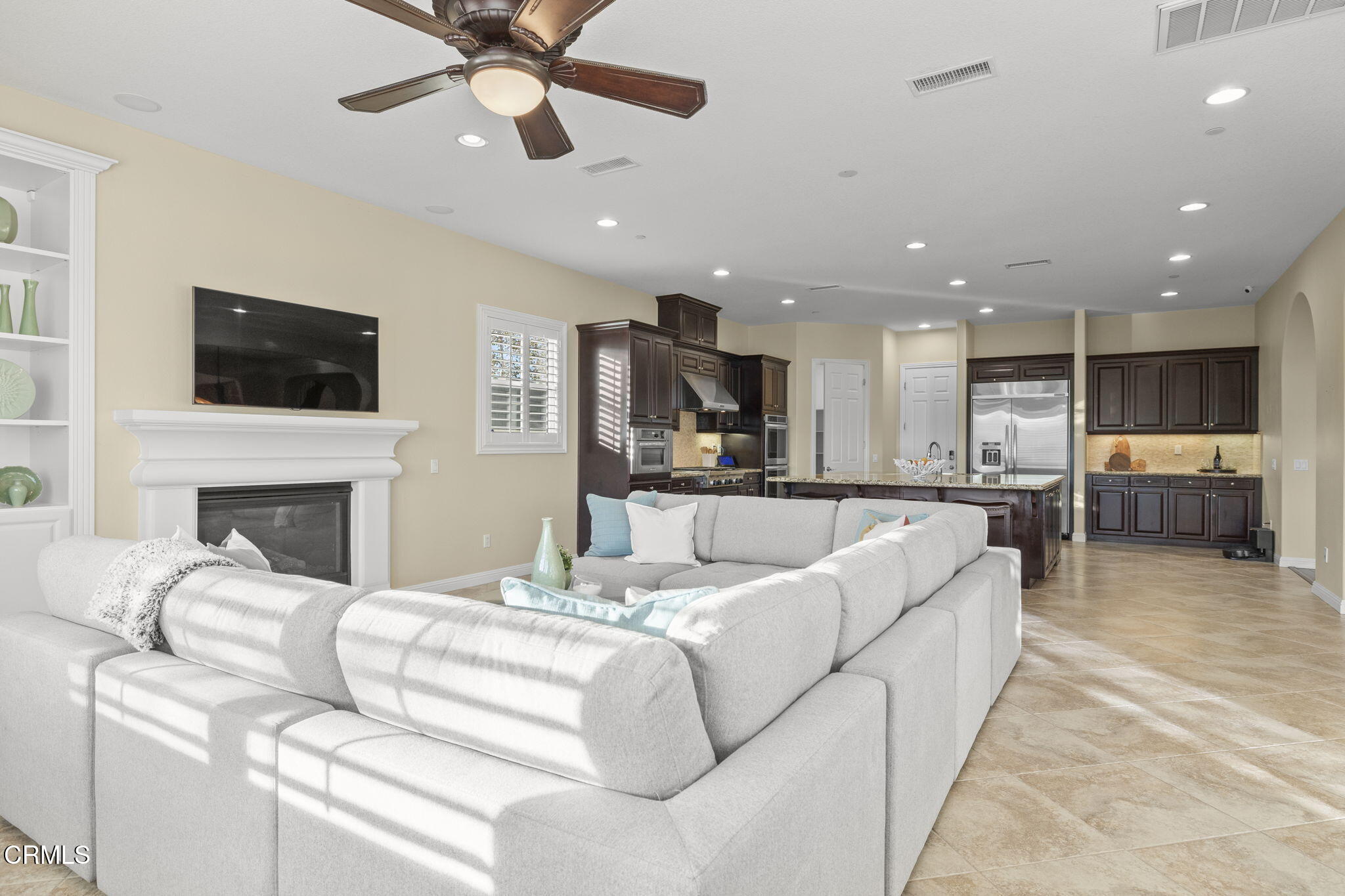 7391 Elk Run Way Moorpark, CA 93021 - Photo 24 of 56 a living room with fireplace furniture and a flat screen tv