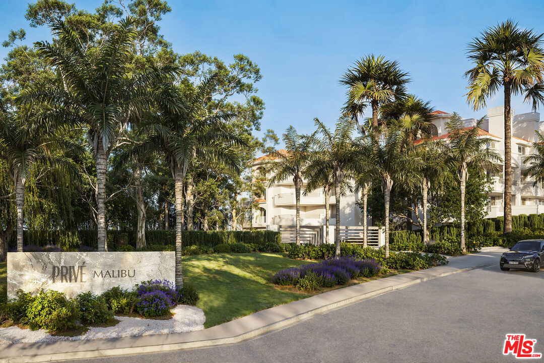 6487 Cavalleri Road, Unit 228 Malibu, CA 90265 - Photo 18 of 18 a view of a street with a cars parked and small park