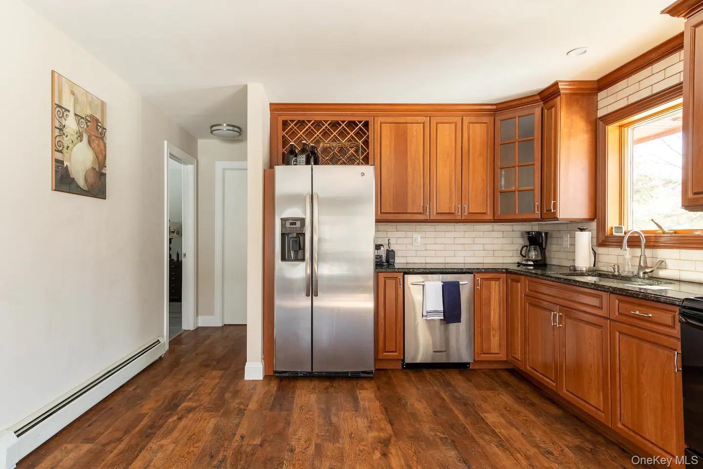 33 South Liberty Road Liberty, NY 12754 - Photo 3 of 12 a kitchen with stainless steel appliances granite countertop a refrigerator and wooden cabinets