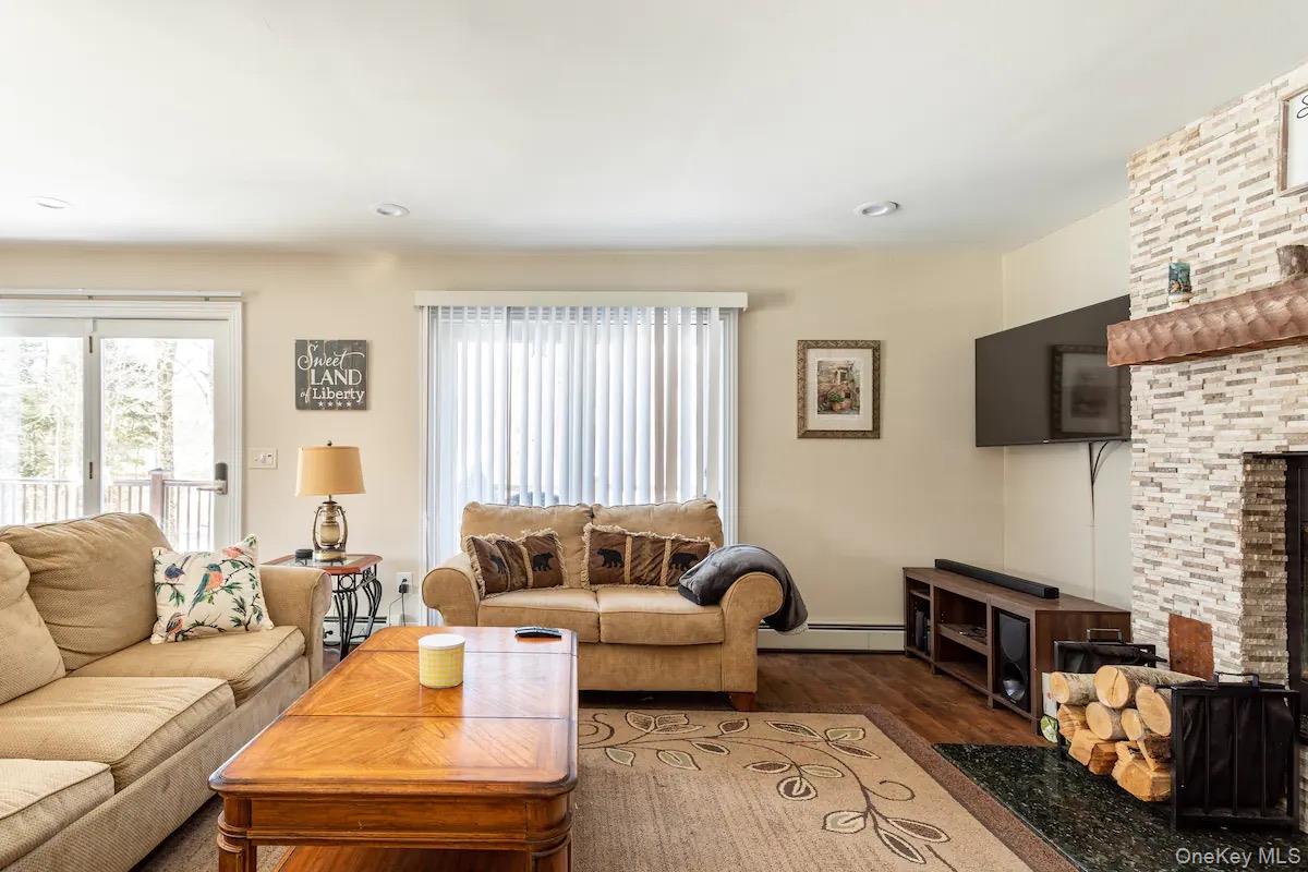 33 South Liberty Road Liberty, NY 12754 - Photo 5 of 12 a living room with furniture fireplace and a flat screen tv
