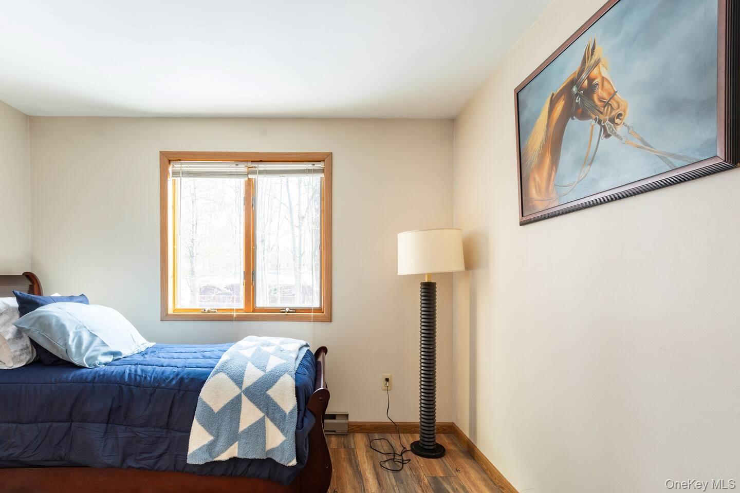 33 South Liberty Road Liberty, NY 12754 - Photo 8 of 12 a bedroom with a bed and a window